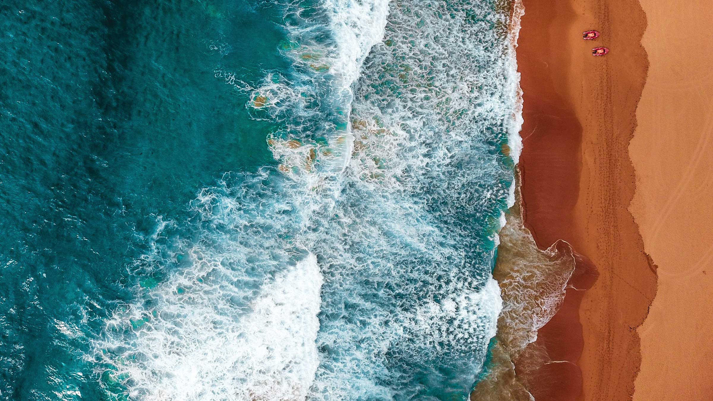Ocean waves meeting a sandy shoreline