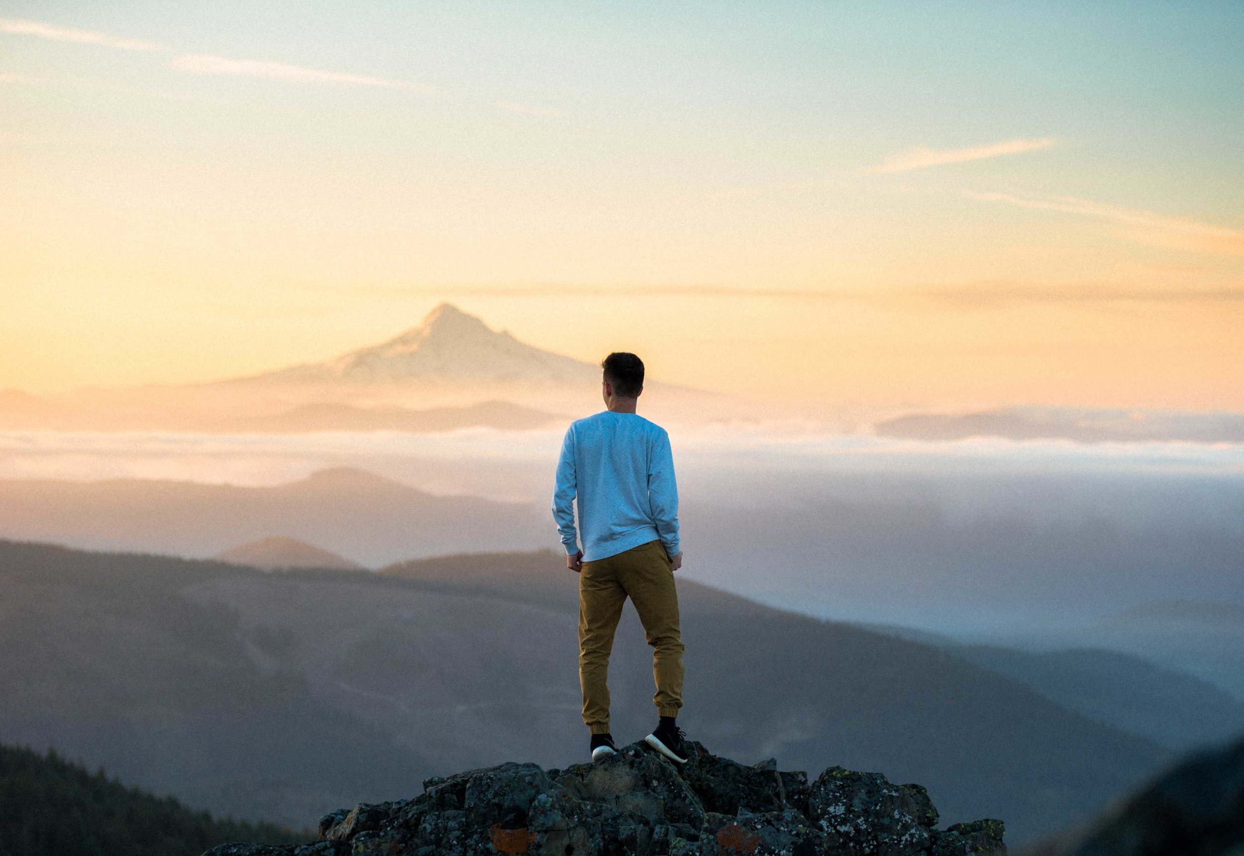 A person looking toward distant mountains